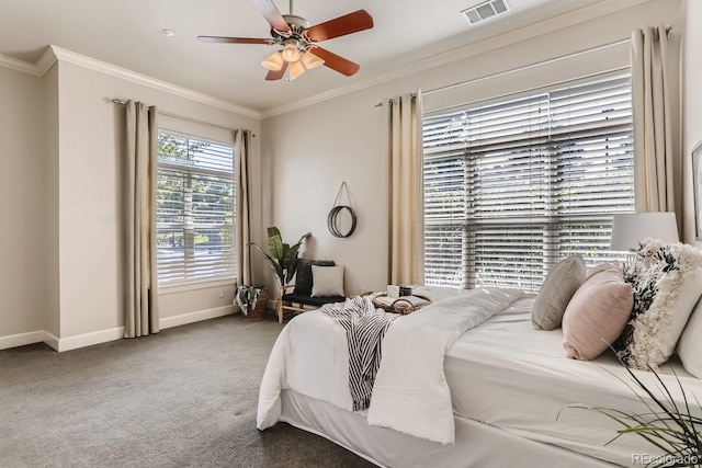 carpeted bedroom featuring a ceiling fan, crown molding, baseboards, and visible vents