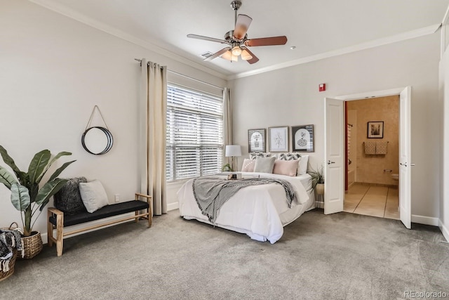 tiled bedroom with baseboards, ornamental molding, carpet flooring, ensuite bathroom, and a ceiling fan