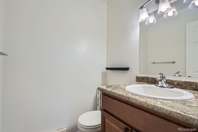 bathroom with vanity, a baseboard heating unit, and toilet