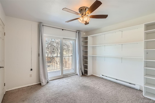 carpeted empty room featuring ceiling fan and a baseboard heating unit