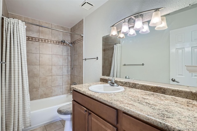 full bathroom with tile patterned floors, vanity, shower / bath combo, and toilet