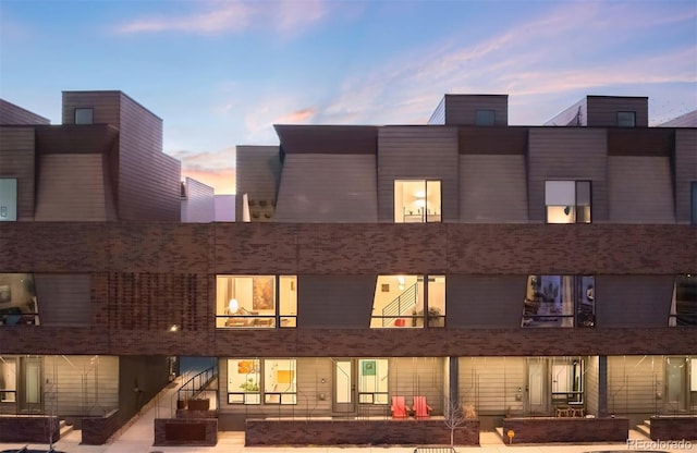 back house at dusk with a patio area