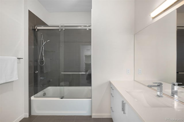 bathroom with tile patterned floors, baseboards, bath / shower combo with glass door, and vanity