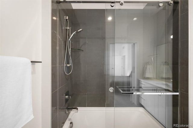 bathroom featuring shower / bath combination with glass door