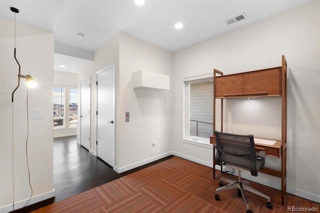 office space with recessed lighting, visible vents, and baseboards