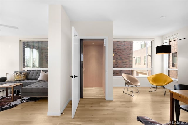 living area with light wood finished floors and baseboards