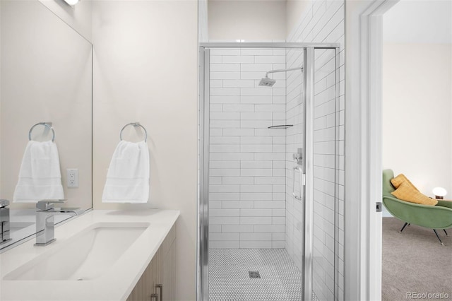 bathroom with a shower stall and vanity