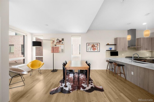 dining room with baseboards and light wood finished floors