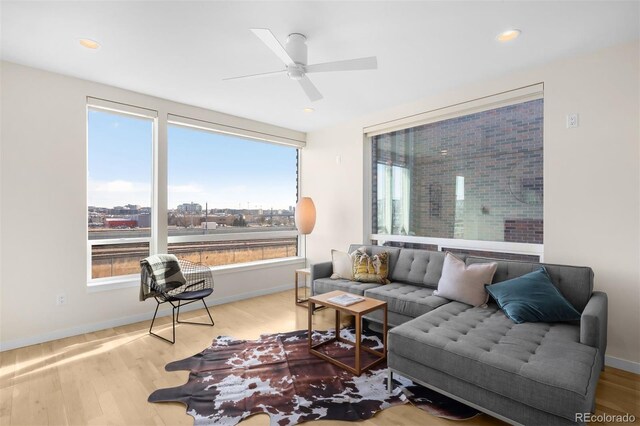 living room featuring recessed lighting, wood finished floors, a ceiling fan, and baseboards