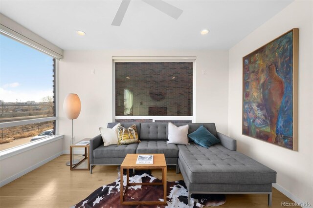 living area featuring recessed lighting, ceiling fan, baseboards, and wood finished floors