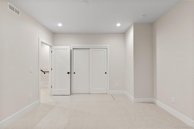 unfurnished bedroom with visible vents, recessed lighting, carpet flooring, and baseboards