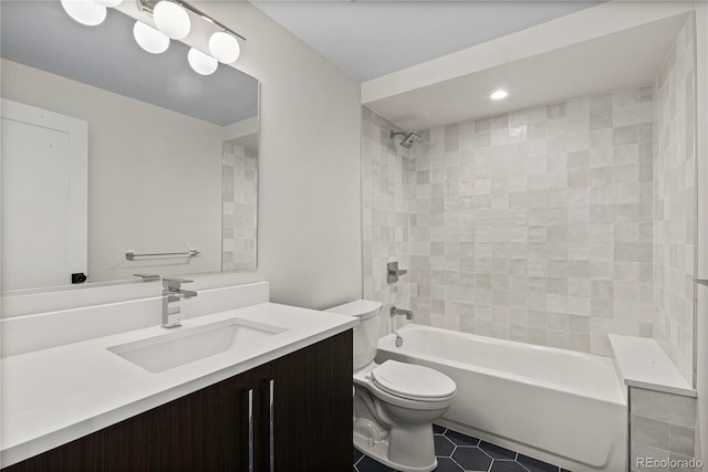 bathroom featuring tile patterned flooring, tub / shower combination, toilet, and vanity