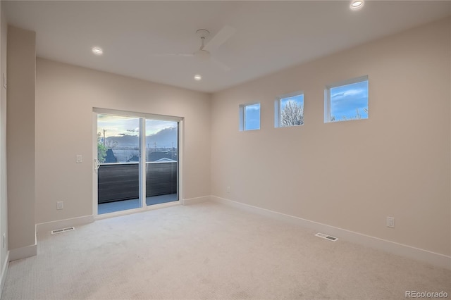 empty room with ceiling fan, light carpet, recessed lighting, baseboards, and visible vents