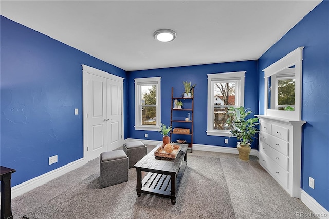 sitting room with carpet floors and plenty of natural light