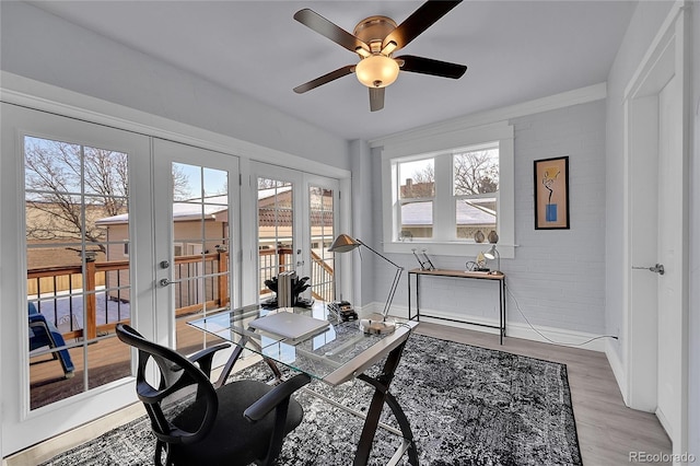 office area featuring ceiling fan, brick wall, light wood-type flooring, and french doors