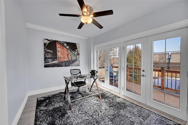 office featuring wood-type flooring, ceiling fan, crown molding, and french doors