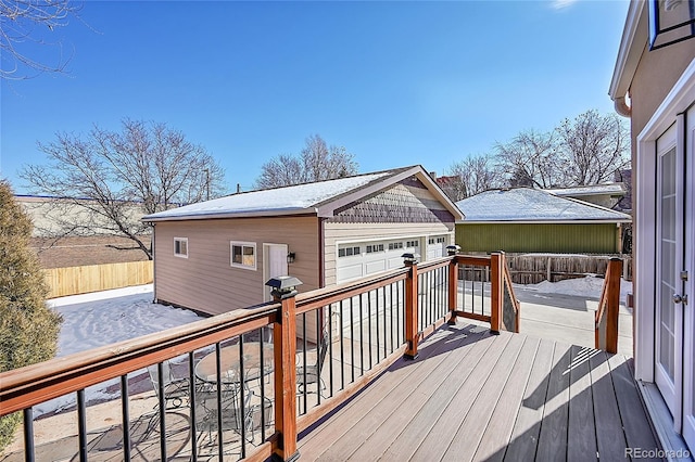 deck with a garage, an outbuilding, and grilling area