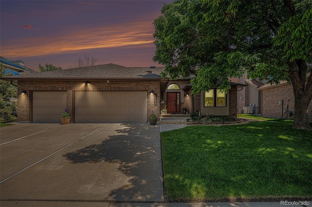 1152 Clubhouse Dr, Broomfield, CO 80020 - view of front of home featuring driveway, an attached garage, a yard, and brick siding