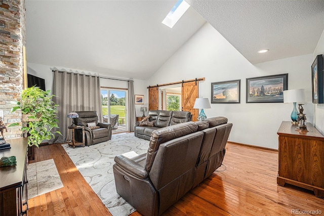 1152 Clubhouse Dr, Broomfield, CO 80020 - living room featuring high vaulted ceiling, wood-type flooring, a skylight, and baseboards