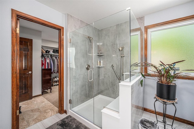 1152 Clubhouse Dr, Broomfield, CO 80020 - full bath featuring a shower stall, a walk in closet, and baseboards