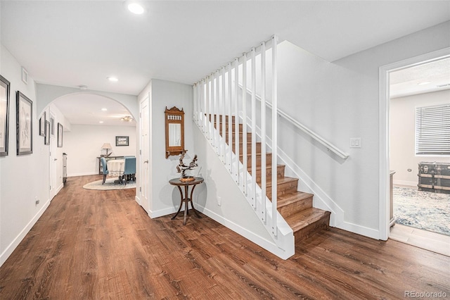 1152 Clubhouse Dr, Broomfield, CO 80020 - stairs with wood finished floors, arched walkways, baseboards, and recessed lighting