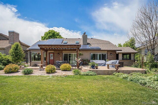 1152 Clubhouse Dr, Broomfield, CO 80020 - back of house with a patio area, a yard, solar panels, and brick siding