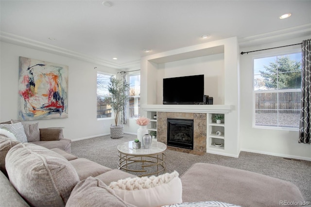 carpeted living room featuring a tile fireplace