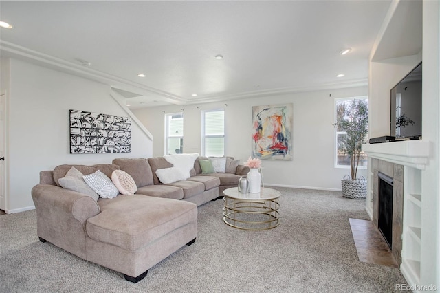 carpeted living room featuring a healthy amount of sunlight and a tiled fireplace