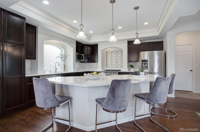 kitchen featuring dark brown cabinets, stainless steel appliances, and a kitchen island