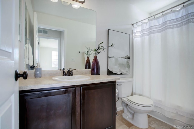 bathroom featuring vanity, toilet, and walk in shower