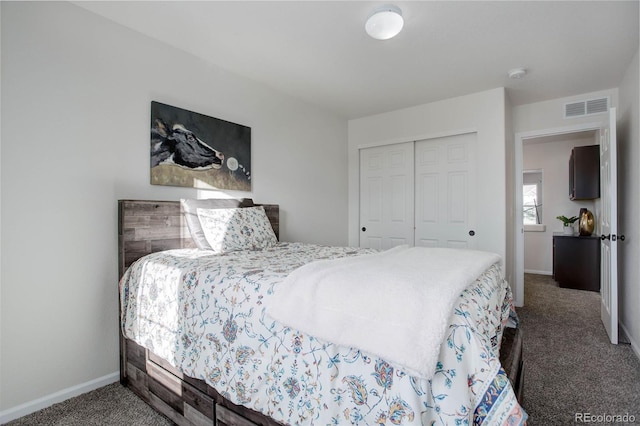 bedroom featuring a closet and dark carpet