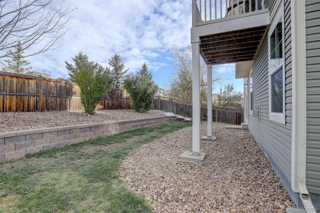 view of yard with a balcony