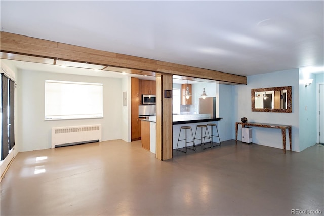 500 E 11th Ave Unit 201, Denver, CO 80203 - living area featuring radiator and finished concrete flooring
