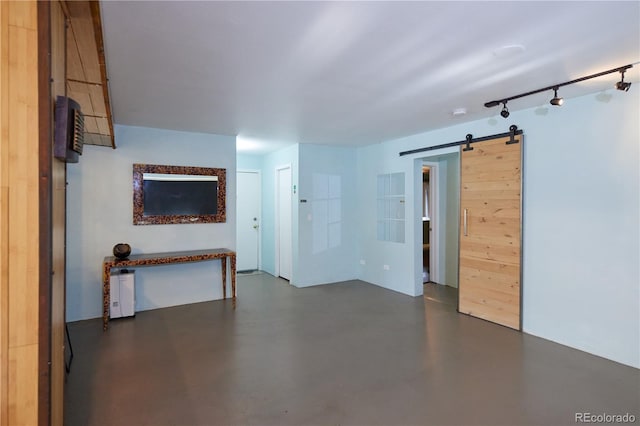 500 E 11th Ave Unit 201, Denver, CO 80203 - unfurnished living room featuring a barn door, concrete floors, and track lighting