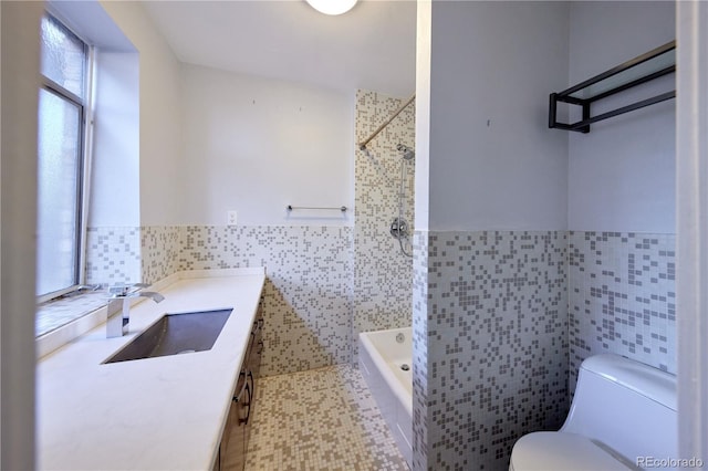 500 E 11th Ave Unit 201, Denver, CO 80203 - bathroom featuring tile walls, vanity, tub / shower combination, and wainscoting
