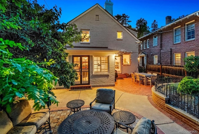 428 N Humboldt St, Denver, CO 80218 - back of property with a patio area, a chimney, brick siding, entry steps, and outdoor dining area