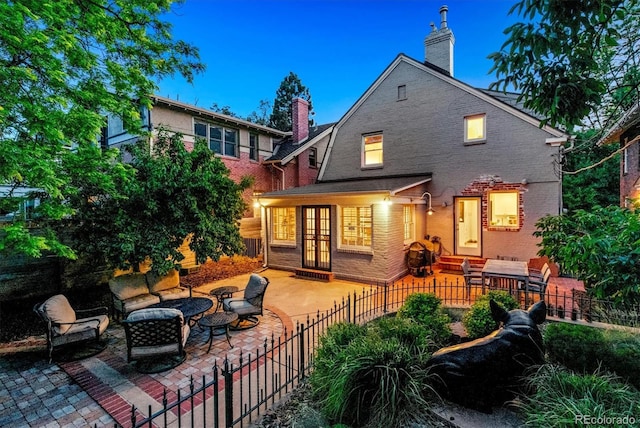 428 N Humboldt St, Denver, CO 80218 - rear view of house with a chimney, a patio area, french doors, an outdoor living space, and brick siding