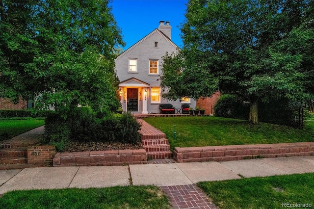 428 N Humboldt St, Denver, CO 80218 - view of front of property featuring a front lawn and a chimney