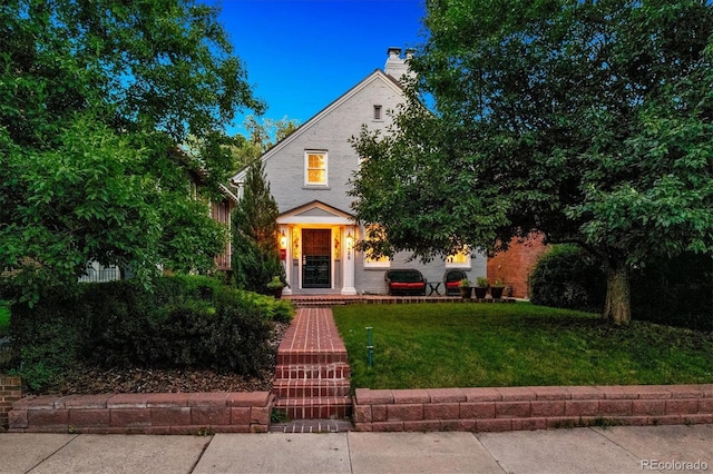 428 N Humboldt St, Denver, CO 80218 - view of property hidden behind natural elements featuring a front yard and a chimney