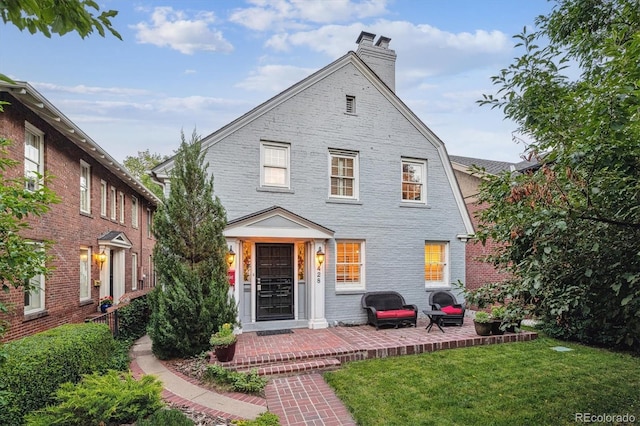 428 N Humboldt St, Denver, CO 80218 - back of property with a chimney, a lawn, and brick siding