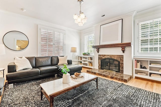 428 N Humboldt St, Denver, CO 80218 - living area with wood finished floors, crown molding, a chandelier, and a tiled fireplace