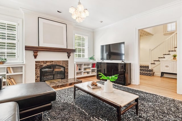 428 N Humboldt St, Denver, CO 80218 - living room with a tiled fireplace, stairs, light wood finished floors, ornamental molding, and a chandelier