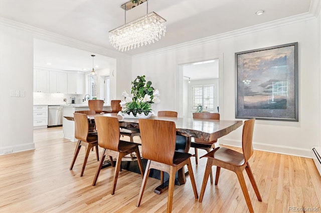 428 N Humboldt St, Denver, CO 80218 - dining space featuring light wood finished floors, ornamental molding, a chandelier, and baseboard heating