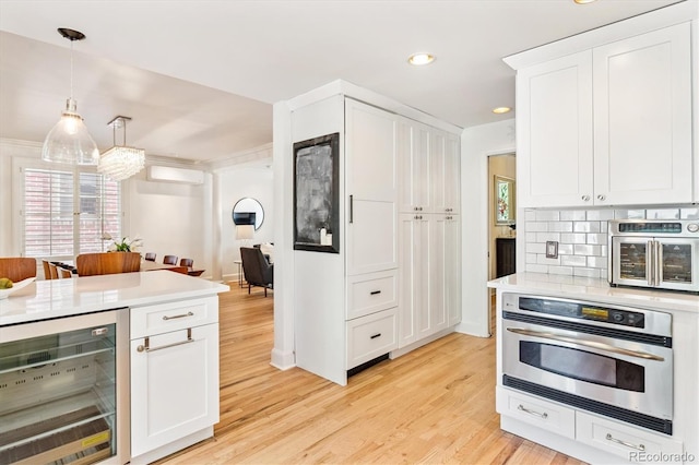 428 N Humboldt St, Denver, CO 80218 - kitchen featuring beverage cooler, stainless steel appliances, light wood-style floors, light countertops, and recessed lighting