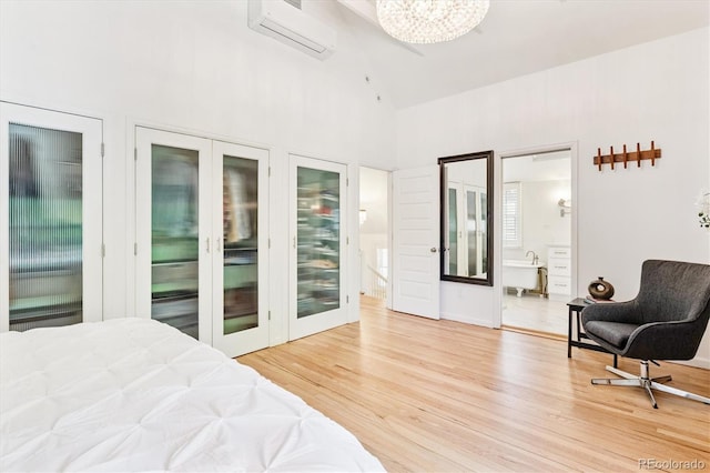 428 N Humboldt St, Denver, CO 80218 - bedroom featuring an AC wall unit, high vaulted ceiling, light wood finished floors, a chandelier, and two closets