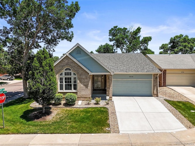 9236 Vrain Ct, Westminster, CO 80031 - ranch-style home with brick siding, an attached garage, a front yard, driveway, and roof with shingles