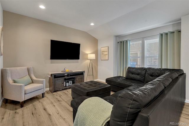 living room with lofted ceiling and light hardwood / wood-style floors