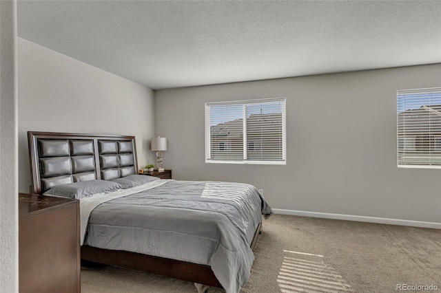 carpeted bedroom featuring multiple windows and a textured ceiling