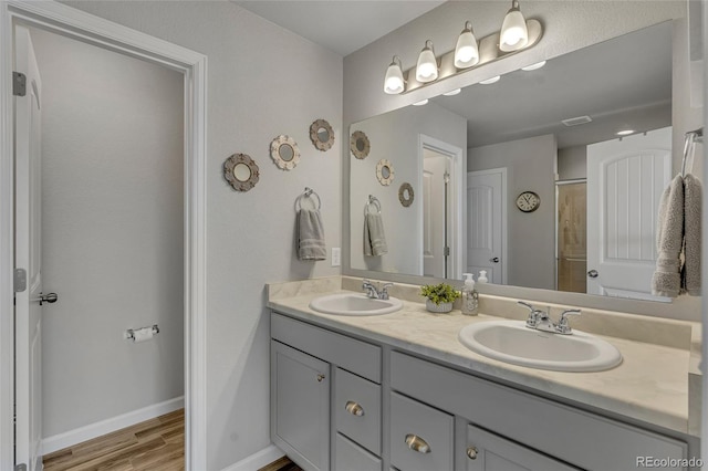 bathroom featuring vanity, hardwood / wood-style flooring, and curtained shower