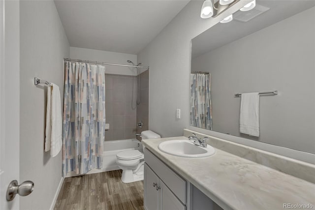 full bathroom featuring vanity, hardwood / wood-style floors, toilet, and shower / bath combo